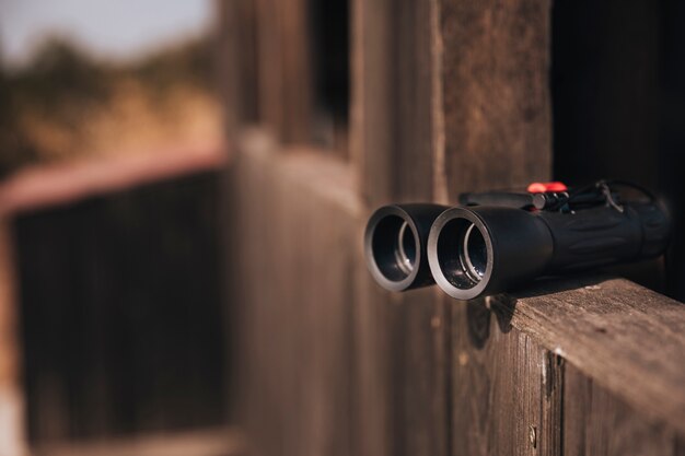 Close-up binoculars on a wooden ledge