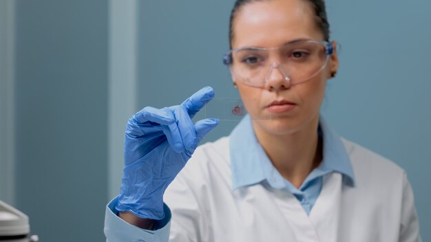 Close up of biology doctor looking at blood test