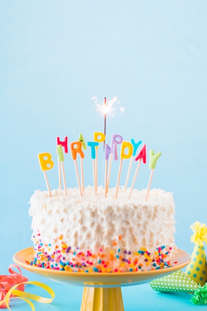 Close-up of birthday cake with burning sparkler