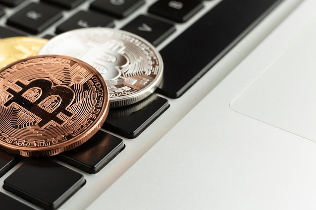 Close-up bitcoin on top of laptop