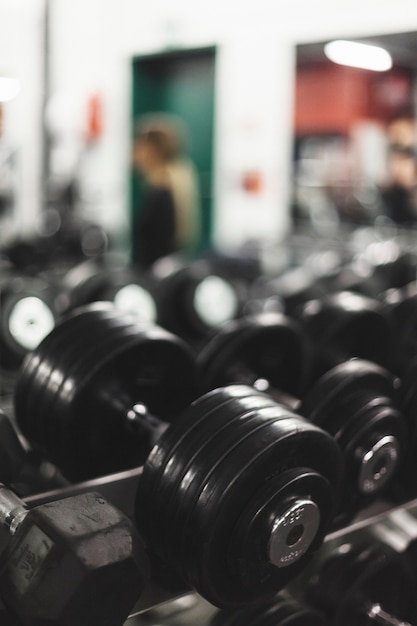 Close-up of a black dumbbell in gym