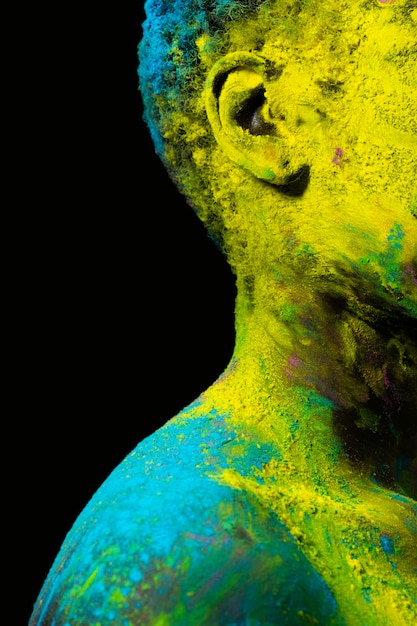 Close up black model posing with colorful powder