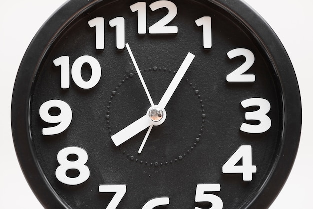 Free photo close-up of a black wall clock face on white background