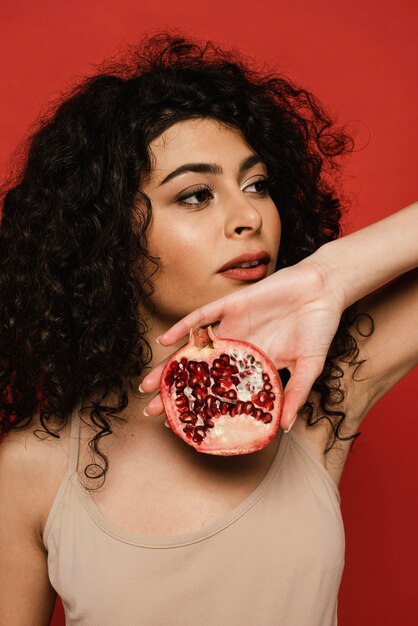 Close-up black woman holding pomegranate