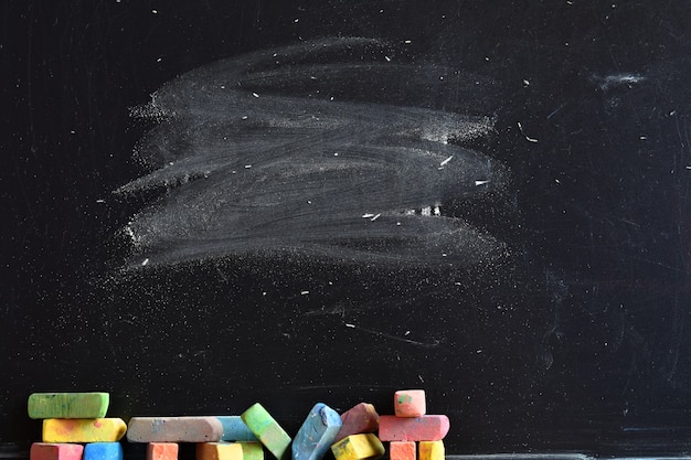 Close-up of blackboard with pieces of colored chalk