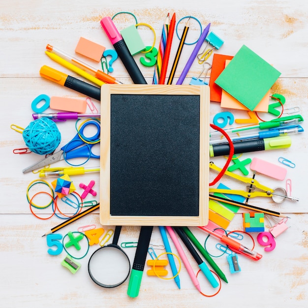 Close-up of blackboard with school supplies.