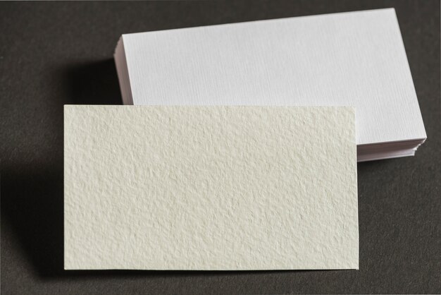 Close-up of blank business cards on grey background