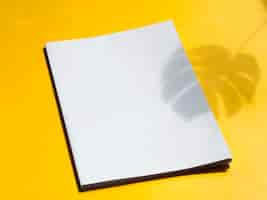 Free photo close-up blank magazine with yellow background