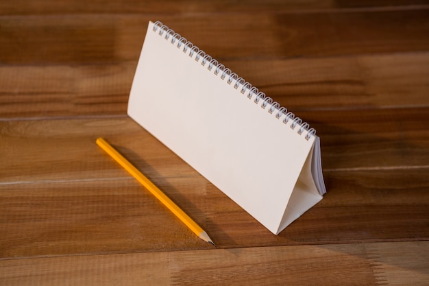 Close-up of blank spiral calendar with a pencil