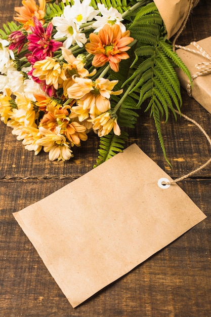 Close-up of blank tag near fresh flowers bouquet