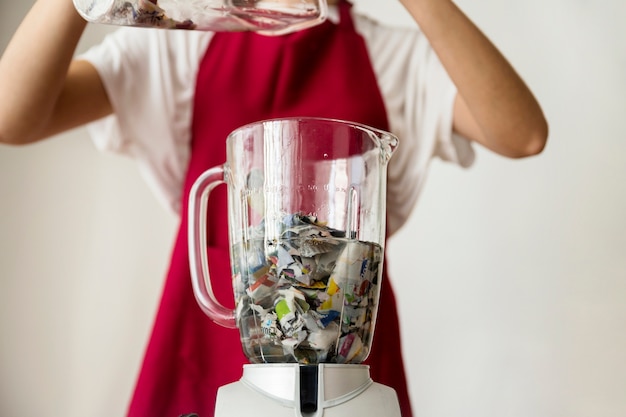 Close-up of a blender filled with water and paper pieces