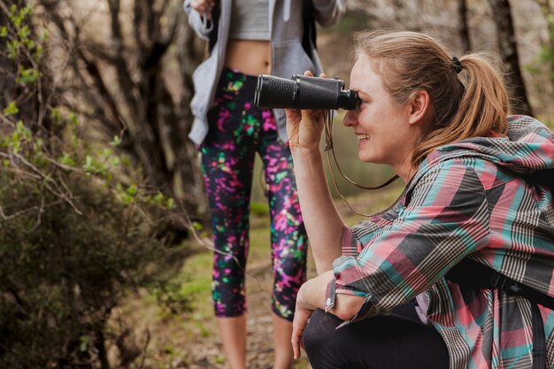 Close-up of blonde girl with binoculars