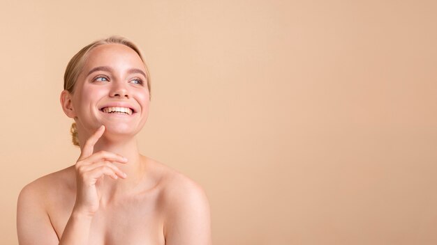 Close-up blonde model with wide smile and copy-space