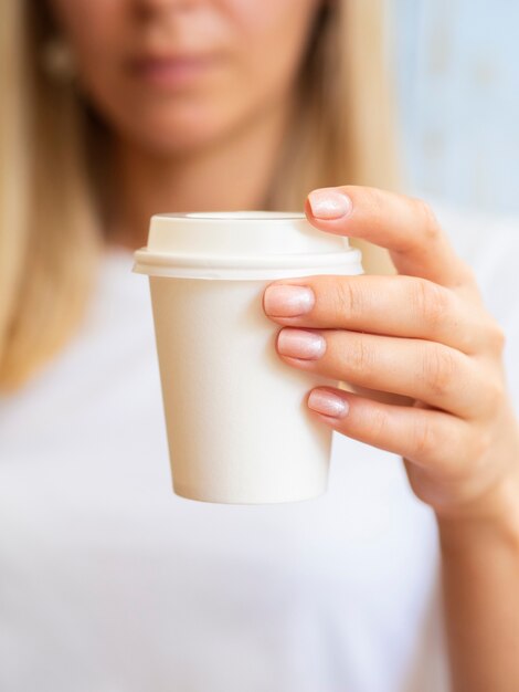 Close-up blonde woman with coffee cup