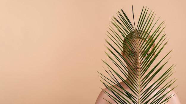 Close-up blonde woman with leaves and copy-space