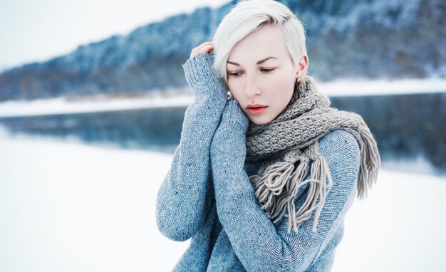 Close-up of blonde woman with short hair in a winter day