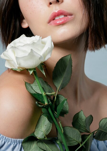 Close-up of bloomed rose with woman