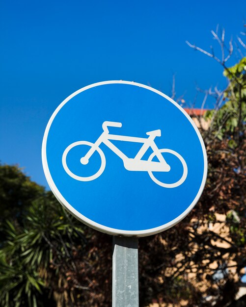 Close-up of blue bike lane sign