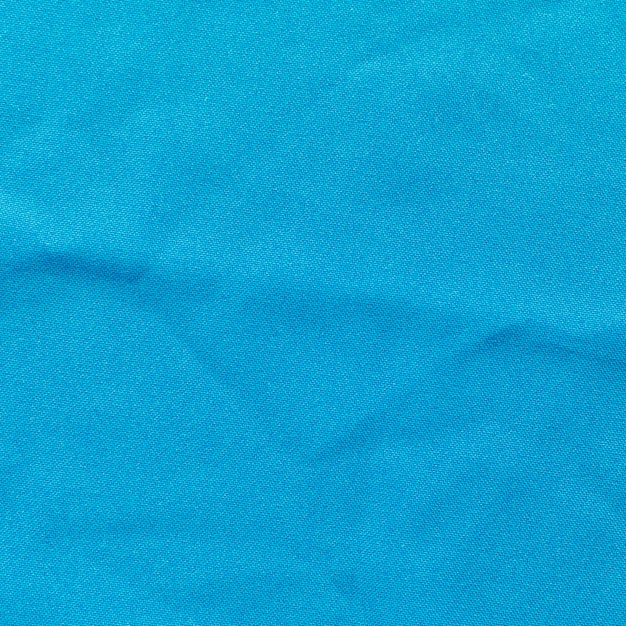 青い布のクローズアップは、背景をテクスチャ