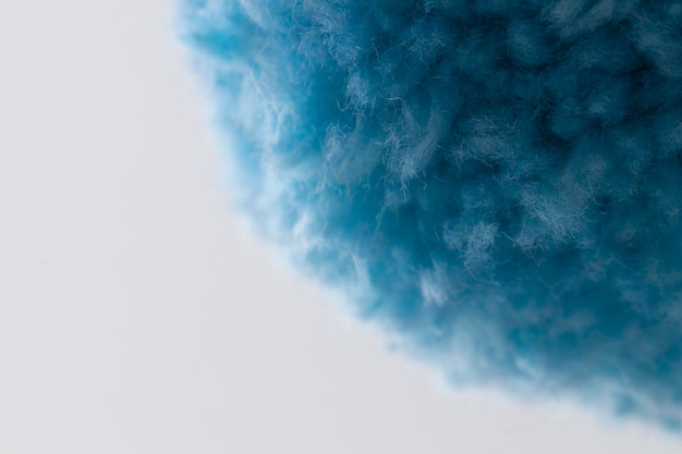 Free photo close up blue pom pom with white background