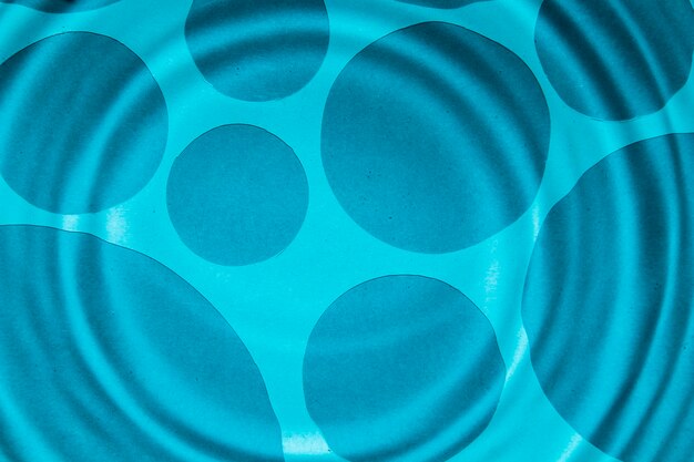 Close-up blue water rings and darker spots