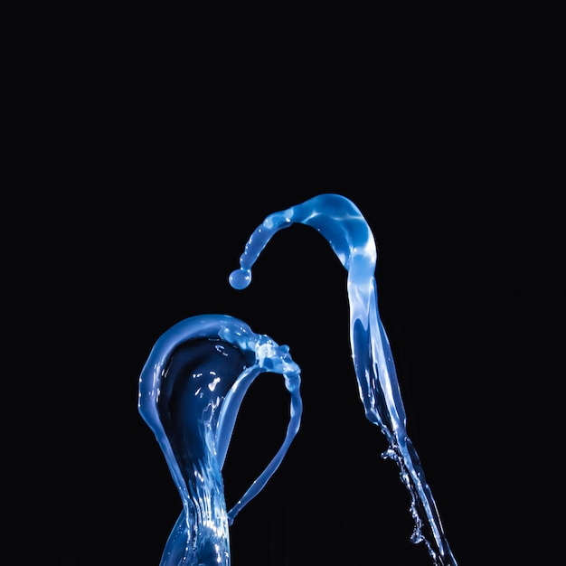 Close-up of a blue waterdrop on black background