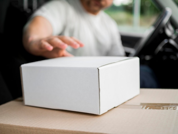 Close-up blurred delivery man in car