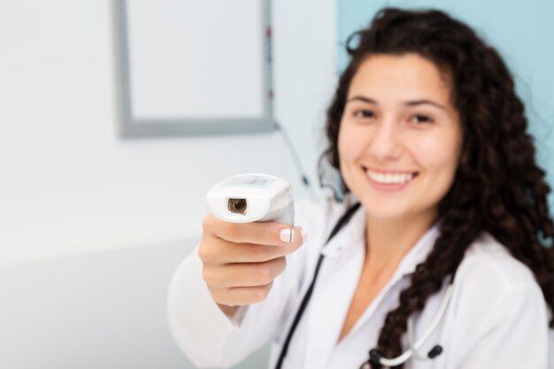 Close-up blurred doctor holding an examination device