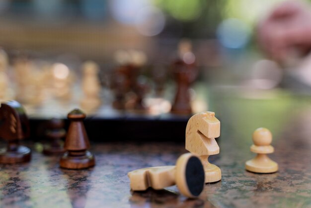 Close up blurry hand and chess pieces