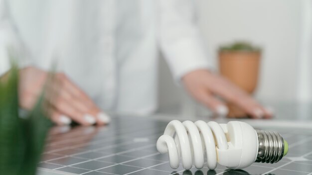 Close up blurry hands and lightbulb