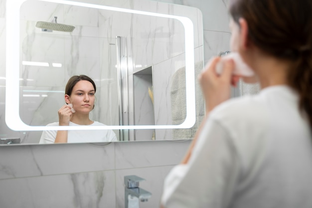 Close up blurry woman using gua sha tool