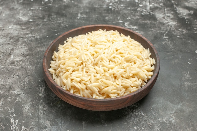 Close up on boiled rice in a brown wooden pot