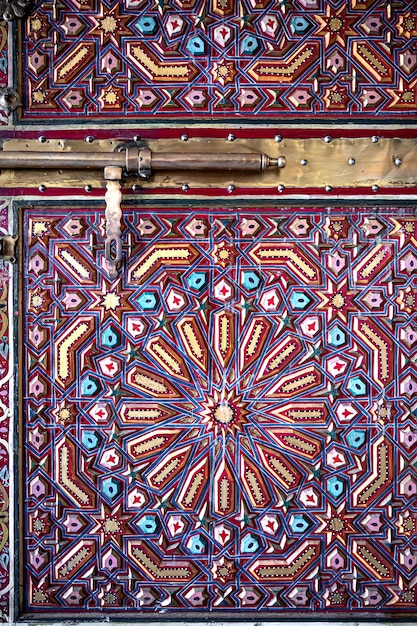 Close up of the bolt on old doors in oriental style with many details