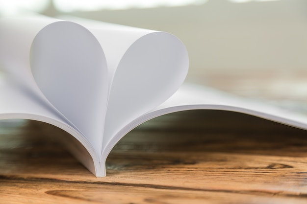 Close-up of book pages forming a heart