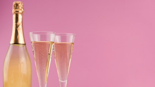 Close-up of bottle of champagne with glasses and copy space