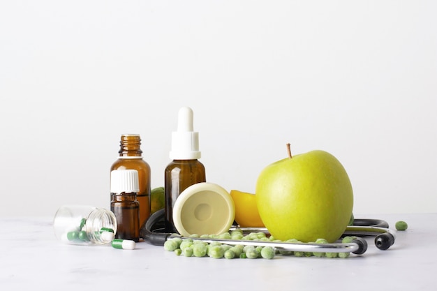 Free photo close-up bottles with oil and pills on the table