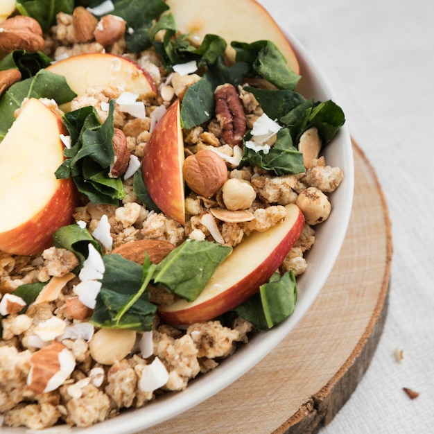 Close-up bowl filled with cereals and slices of apple