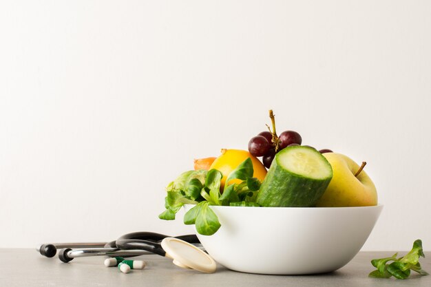 Close-up bowl with cucumber and tasty apple