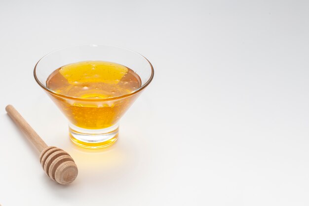 Close-up bowl with honey and stick