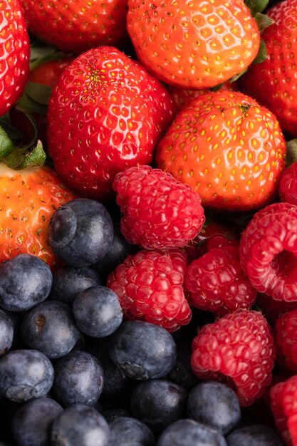 Close-up of bowl with strawberries, raspberries and blueberries