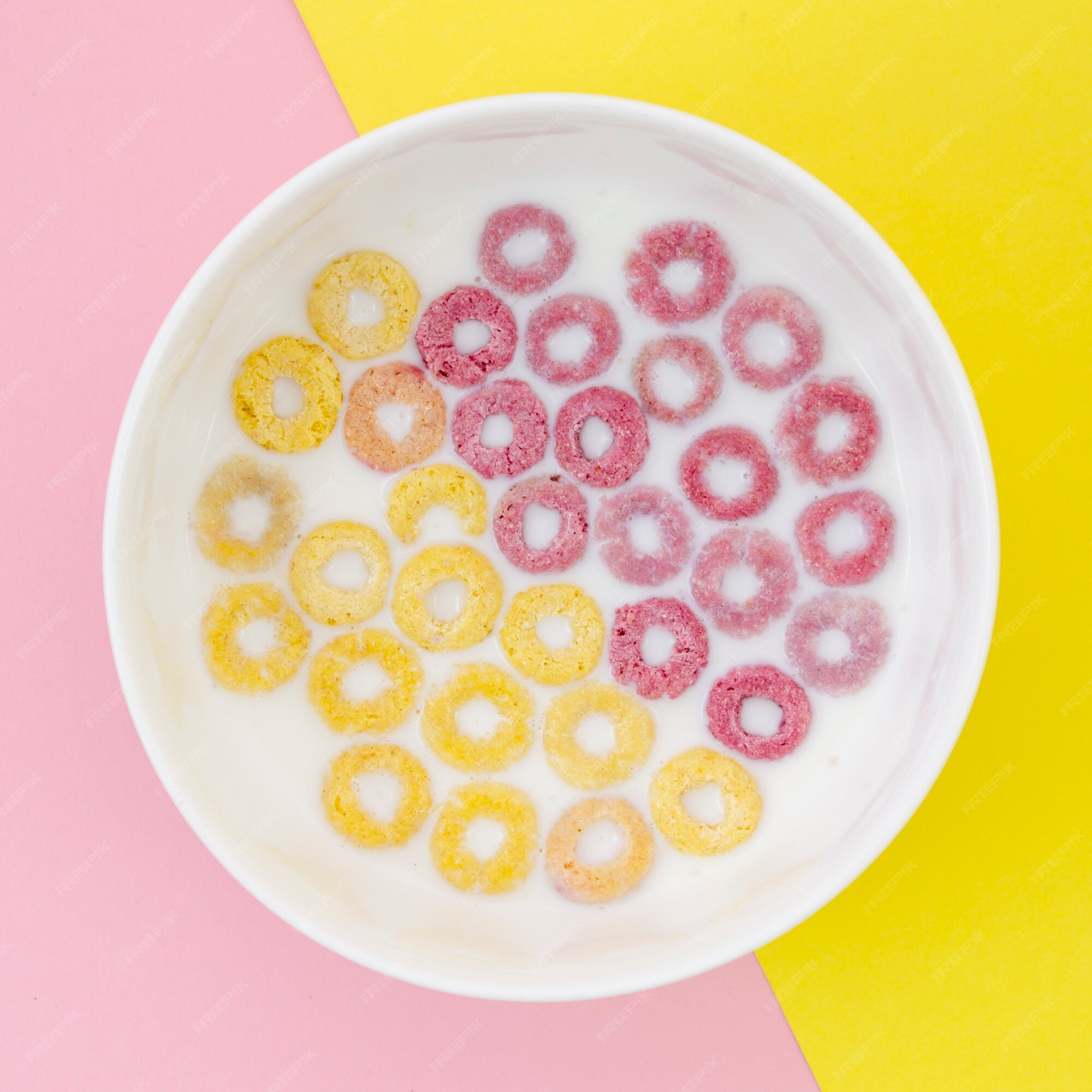 Free Photo  Coloured fruity loops and milk on pink background