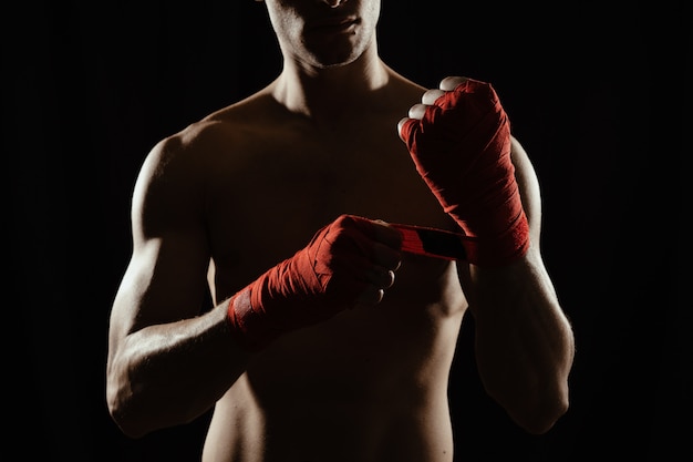 Close up boxer bandaging hands