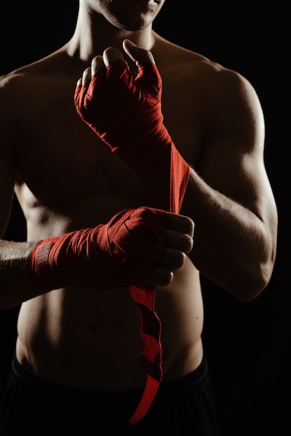 Close up boxer bandaging hands