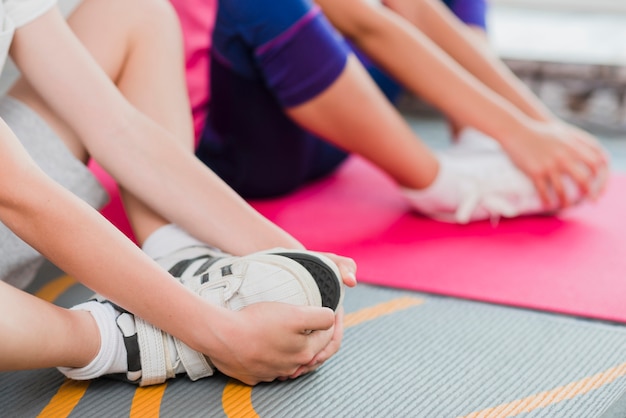 Free photo close-up of boy and girl joining their foot with two hands