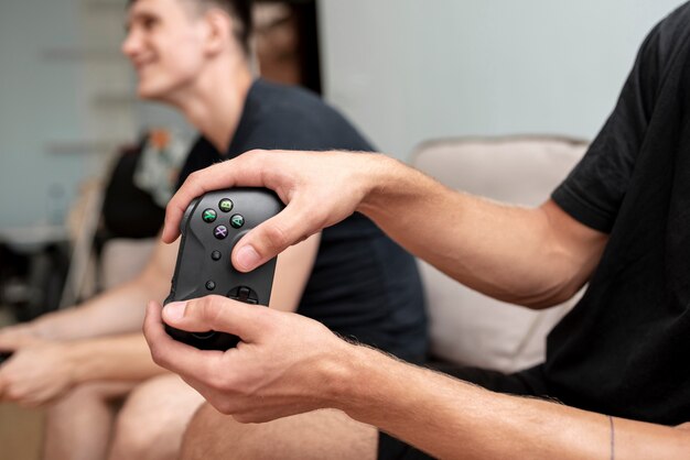 Close-up boy holding a black controller