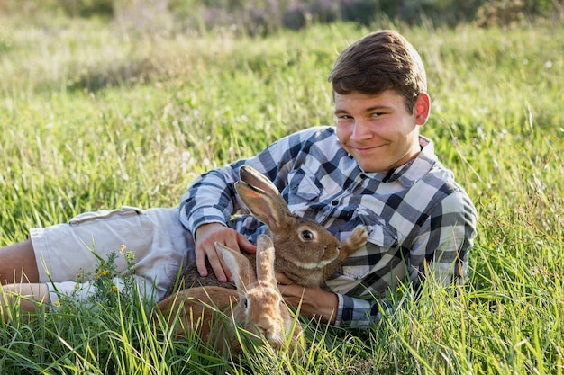 Free photo close-up boy holding rabbit at farm
