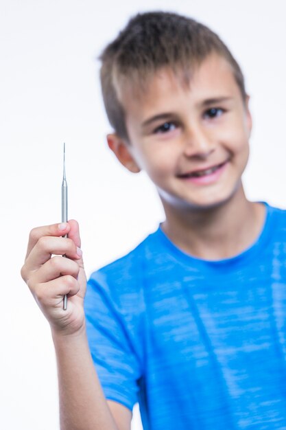 Close-up of a boy holding scaler