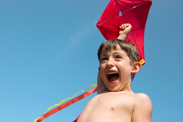 Close up boy playing with kite