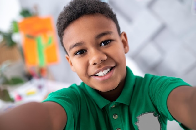 Close up of boys face smiling at camera