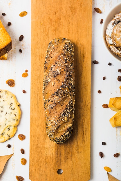 Close-up bread near pastry and raisins 